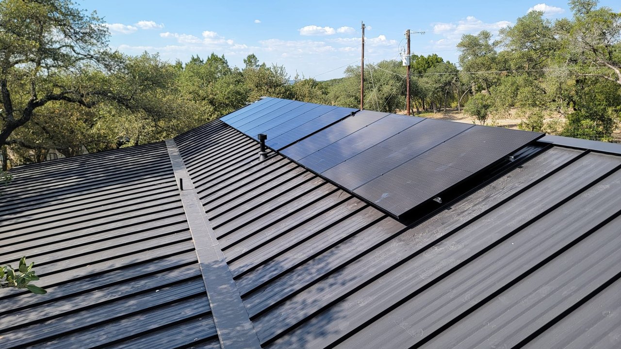New all-black Mission Solar panels on a standing seam metal roof after the upgrade