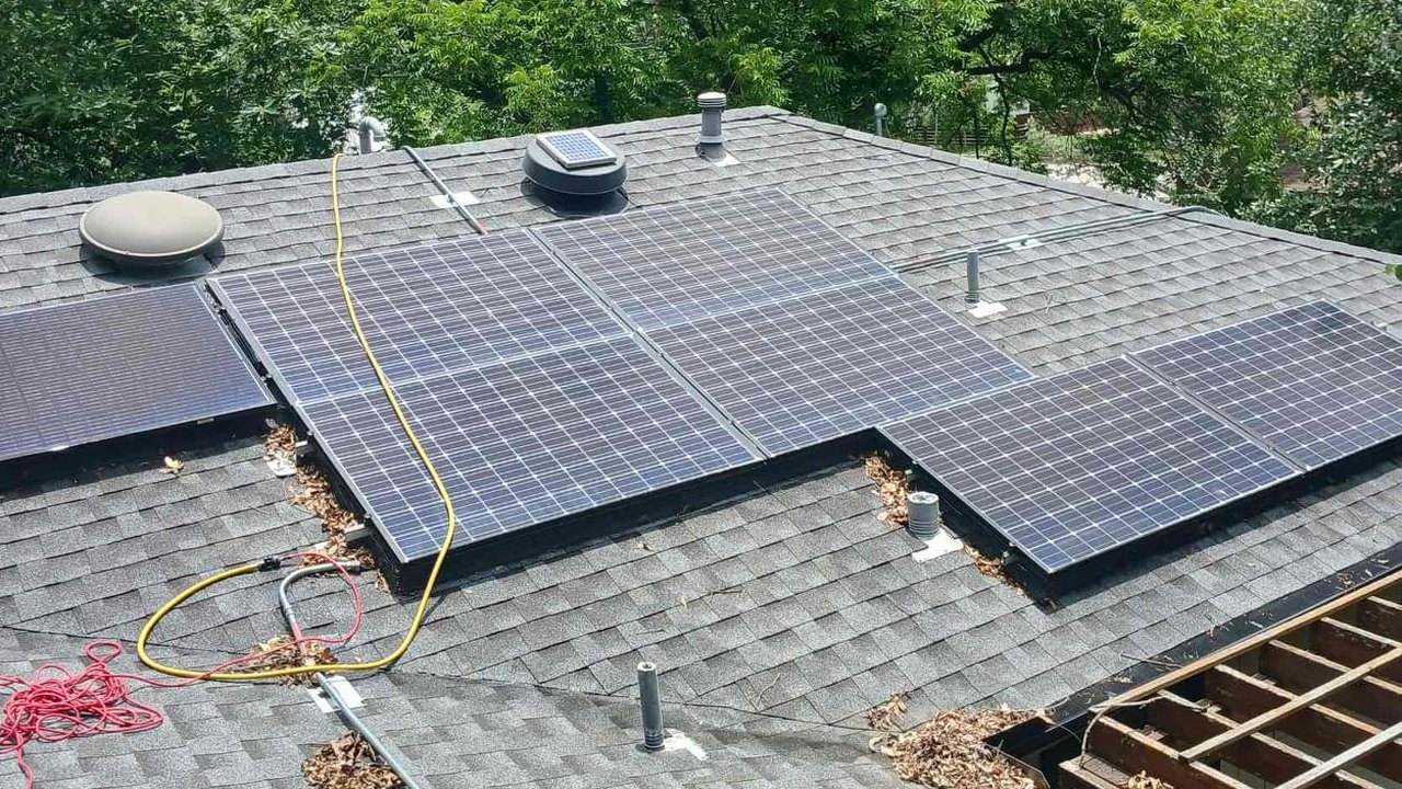 Older mixed solar panels on an Austin roof before the upgrade