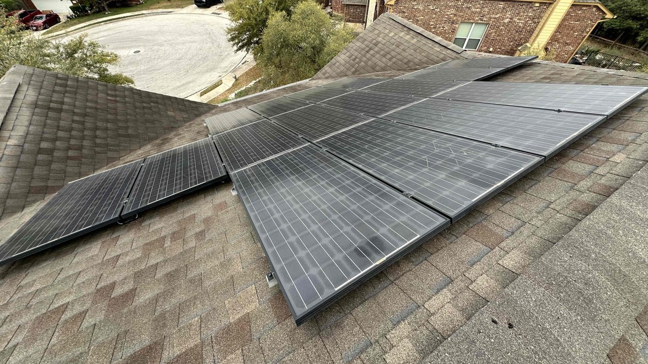 Aging mismatched solar panels on a San Antonio roof before the system upgrade