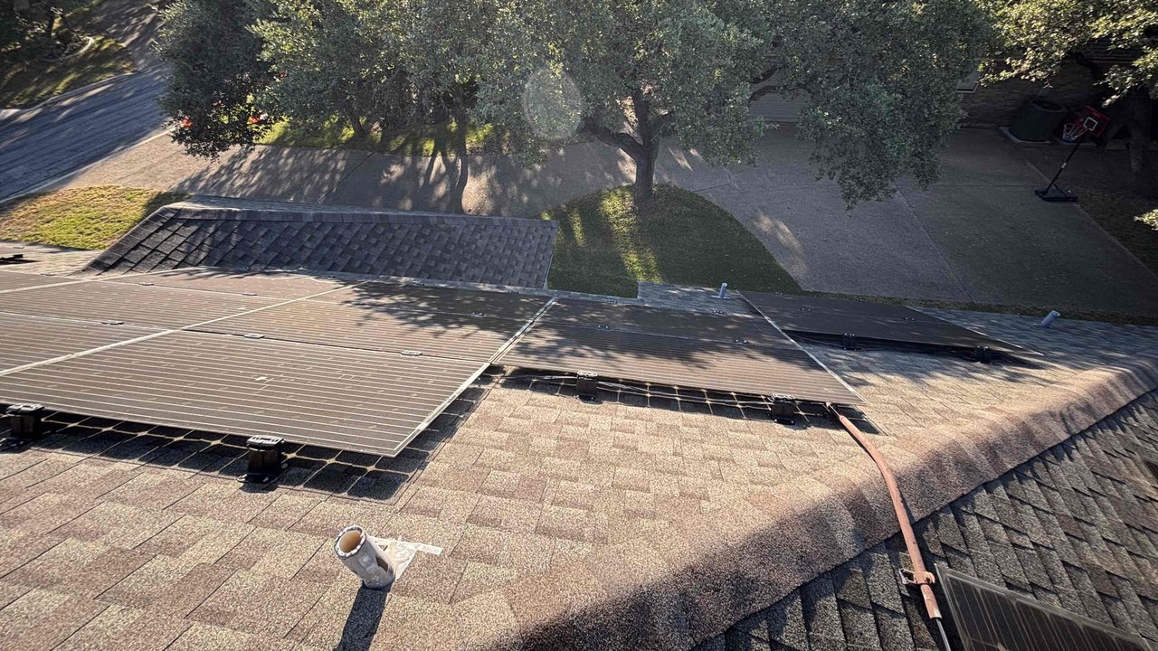 Weathered original solar panels on a Helotes roof before the full system upgrade