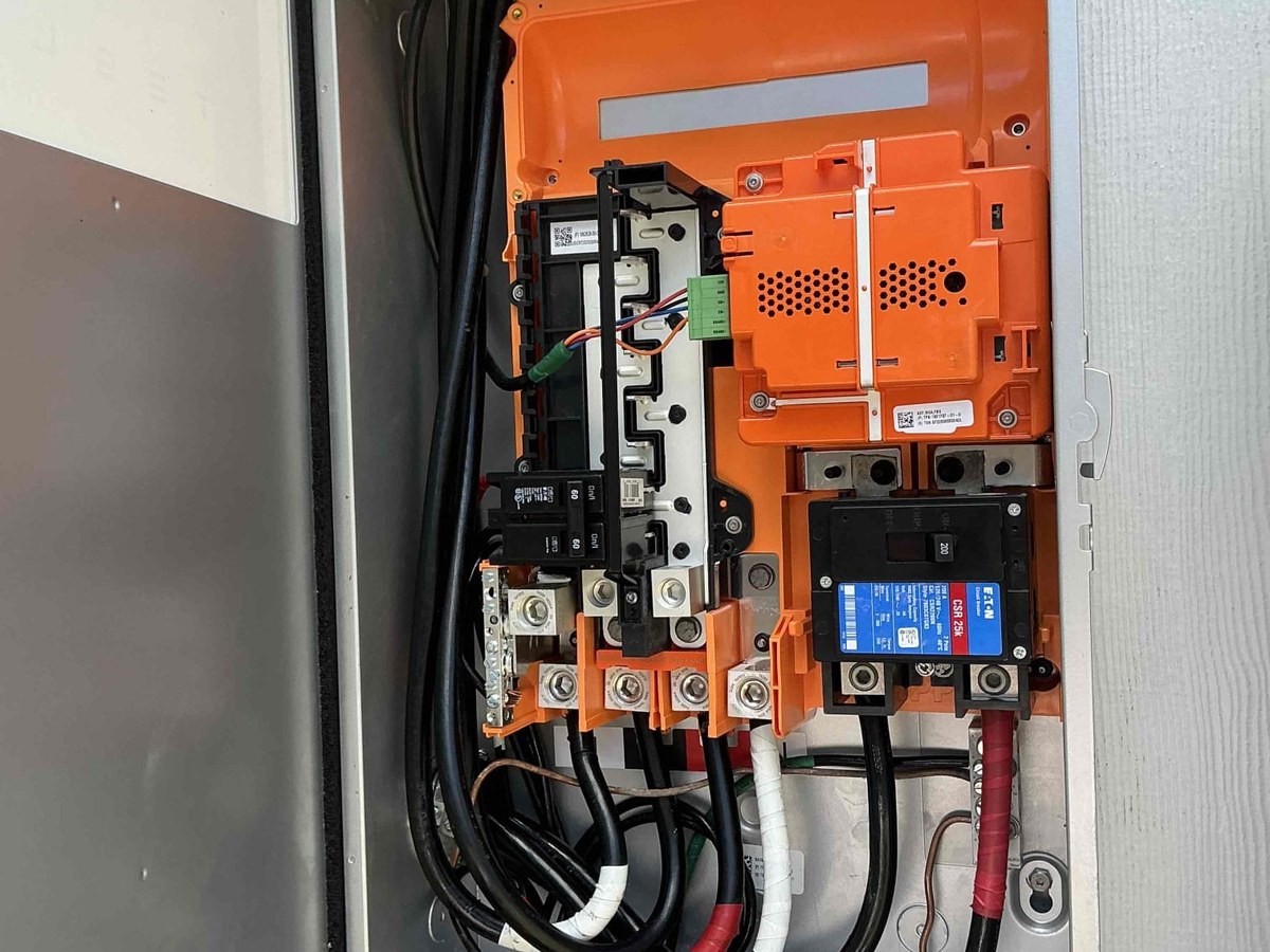 Inside a Tesla Powerwall 3 showing breakers, bus bars and DC wiring during installation