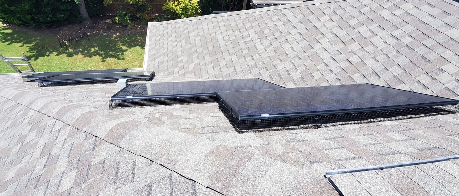 Rooftop solar array with critter guard mesh installed around the perimeter