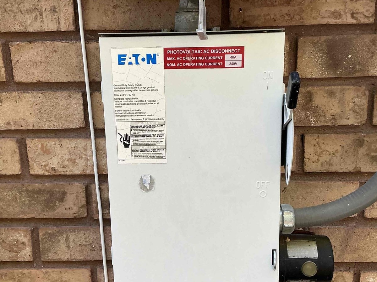 Eaton photovoltaic AC disconnect mounted beside a residential solar inverter
