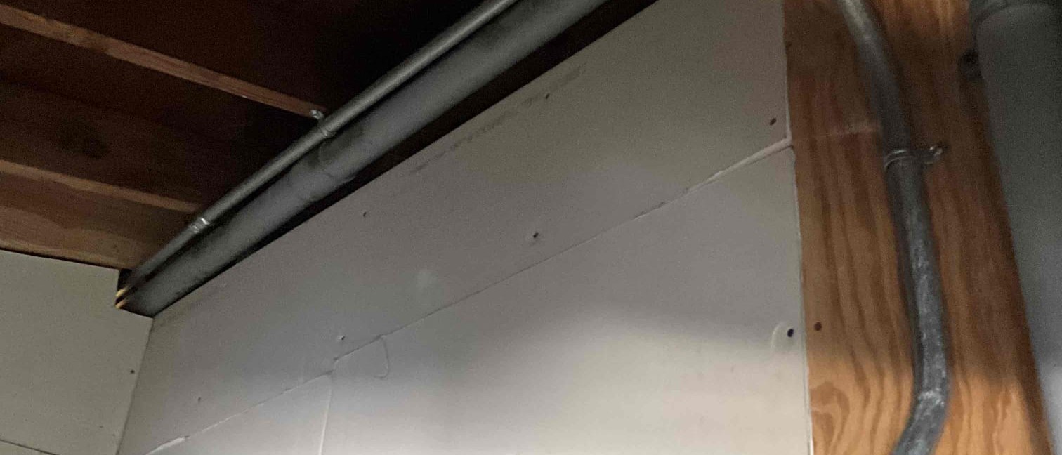 Conduit run installed to carry a new EV charger circuit through a garage