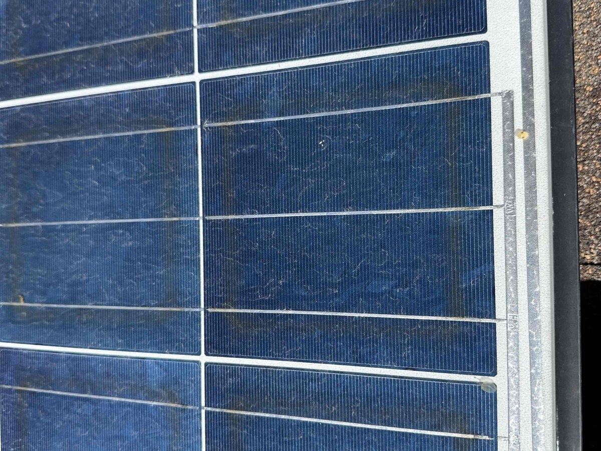 Close-up of solar panel cells showing surface soiling before cleaning