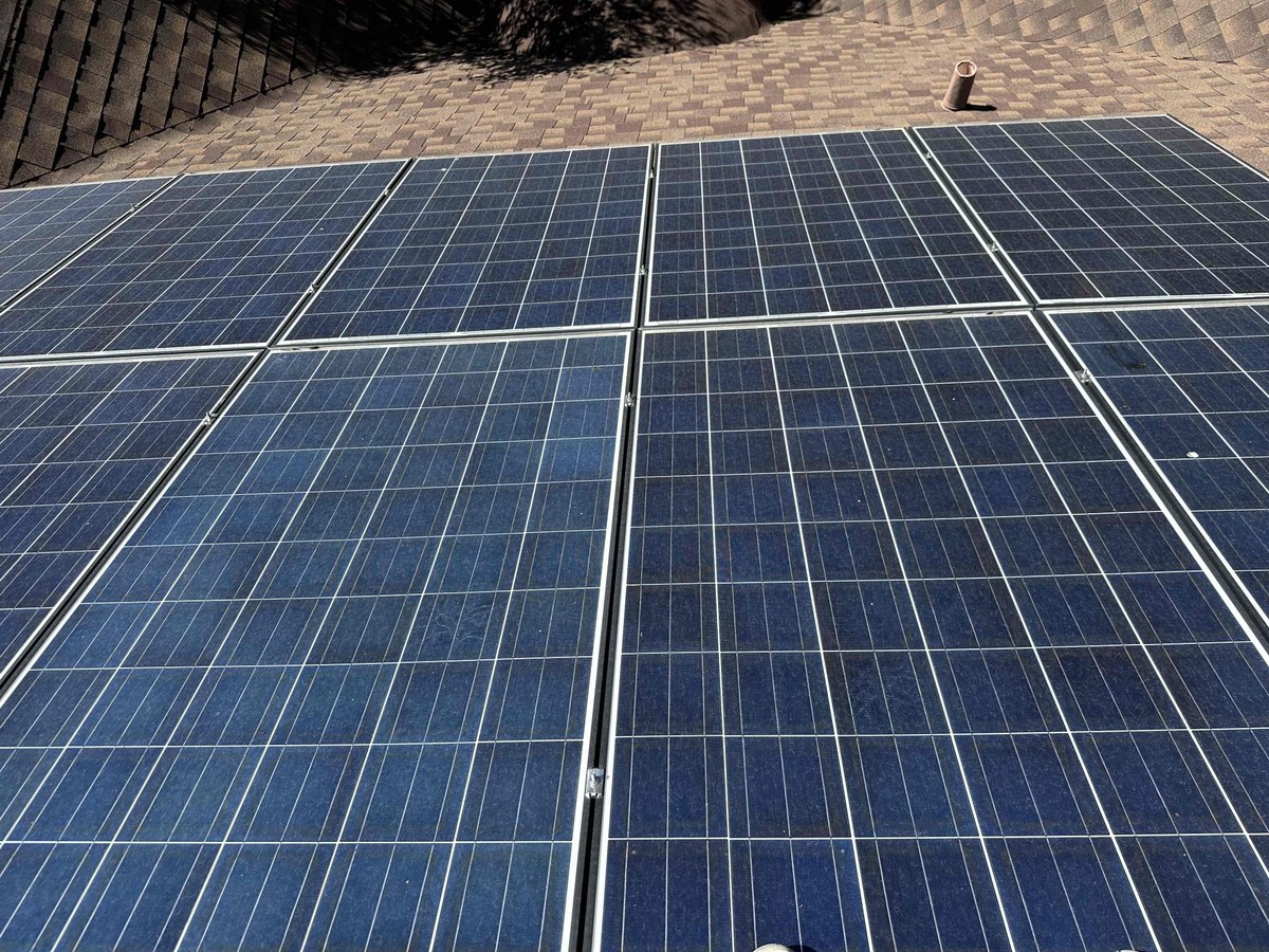 Solar panel surface on a Central Texas rooftop before a professional cleaning